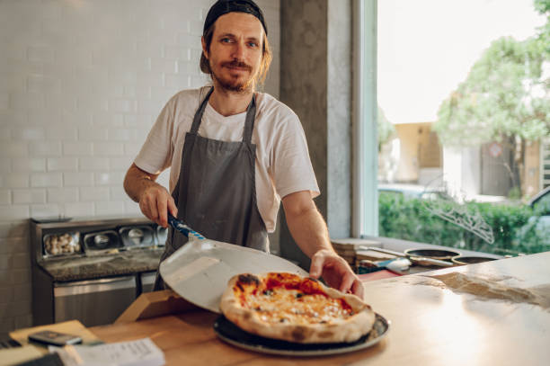 istock Portrait of a kitchen chef working in a pizza place 1402360500