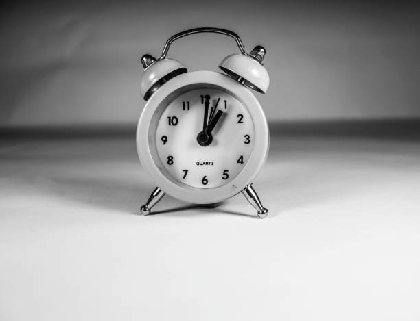 alarm clock in pink color. isolated on white background.