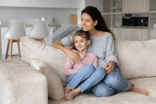 istock Smiling dreamy woman with cute little daughter kid visualizing future 1402361602