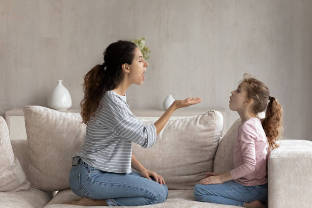 istock Caring mother with little daughter kid speaking, doing speech exercises 1402361610