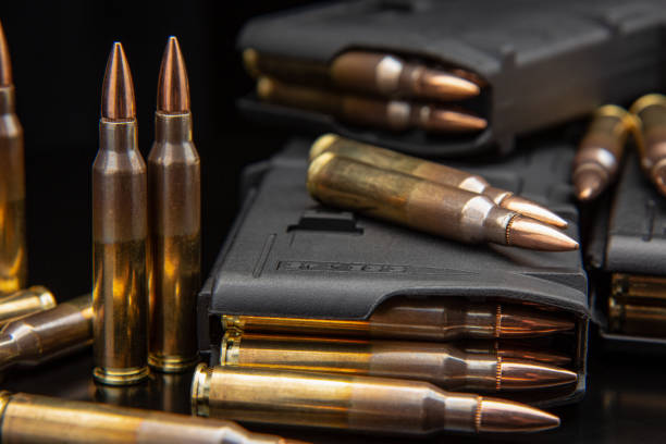 istock Bullet isolated on black background with reflexion. Rifle bullets close-up on black back. Cartridges for rifle and carbine on a black. 1402362792