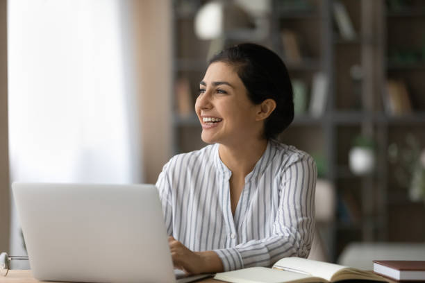 istock Happy millennial Indian woman working in modern office. 1402363730