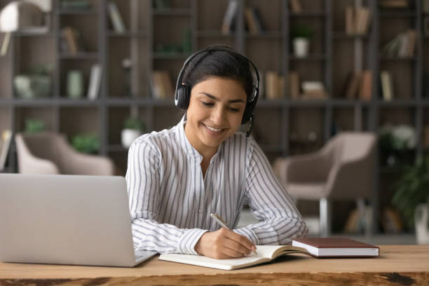 istock Happy beautiful Indian woman studying on online courses. 1402363735