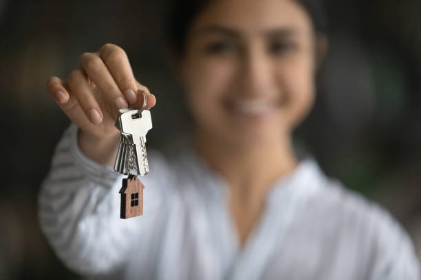 istock Close up focus on keys in female hands. 1402363762