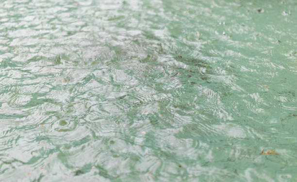 raining on lake water, splashing water
