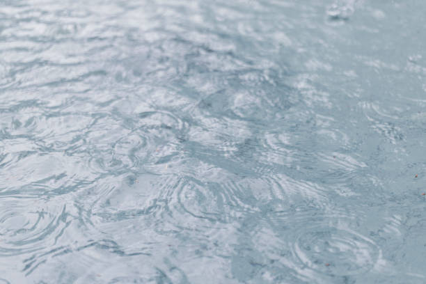 raining on lake water, splashing water