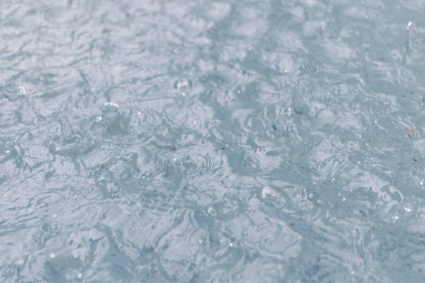raining on lake water, splashing water