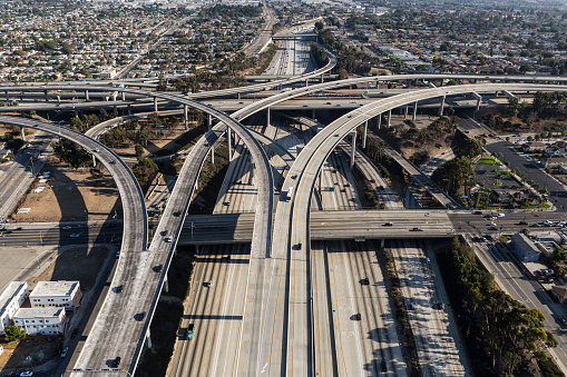 Aerial of ramps, bridges and traffic on the Harbor 110 and Century 105 freeway interchange in Los Angeles County, California.