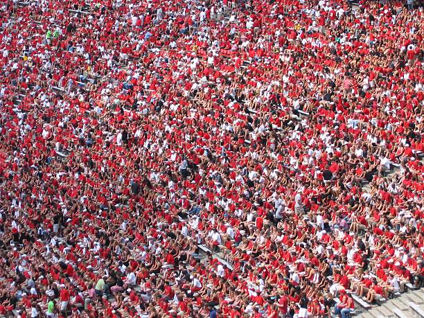 Football Fans Crowd of fans at a football game dressed in red and white georgia football stock pictures, royalty-free photos & images