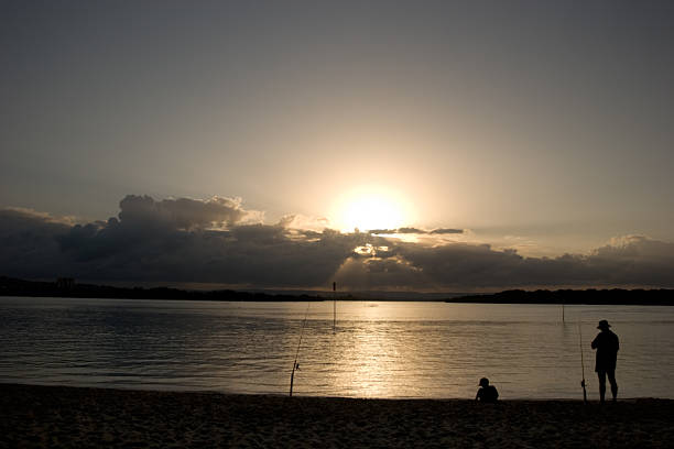 Fishing at sunset stock photo