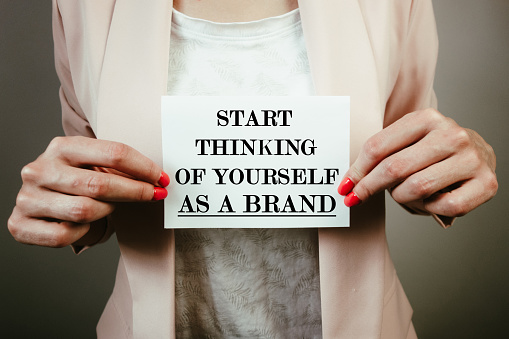 Start thinking of yourself as a brand note in hands of businesswoman. Marketing, branding, individuality, business success concept