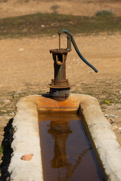 istock Old pump used to extract water from the field 1402366742