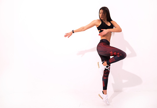 Athletic young woman on white background. Woman exercising and warm up