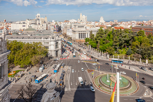 Madrid, Spain - 26th April 2022. Elevated view of the Plaza de Cibeles, Fuente Cibeles, the Banco Español, Jardínes del Palacio de Buenavista, Instituto Cervantes (Edificio de las Cariátides), The Riu Hotel (Edificio Español), the Edificio Telefónica as well as the traffic on Calle de Alcalá and its connecting streets.