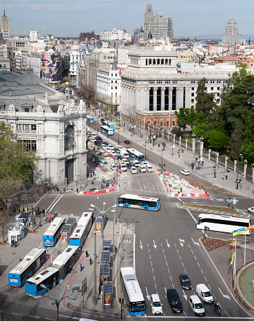 Madrid, Spain - 26th April 2022.  Elevated view of part of central Madrid including Calle de Alcalá, the Night Bus terminus, the HQ of Banco de España, Edificio de Las Cariátides and Edificio Telefónica.