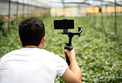 Man shooting with a smartphone connected to a gimbal