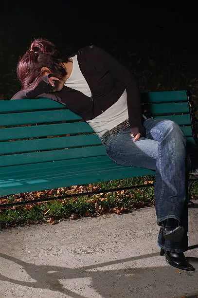 Photo of Crying girl on a park bench
