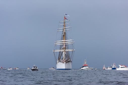 Lindesnes, Norway - August 07 2021: Sail training vessel Statsraad Lehmkuhl greeted by an armada of small boats.