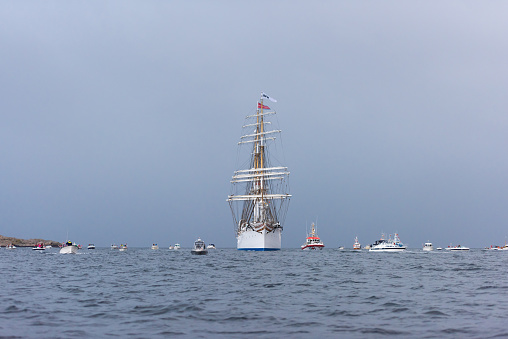 Lindesnes, Norway - August 07 2021: Sail training vessel Statsraad Lehmkuhl greeted by an armada of small boats.