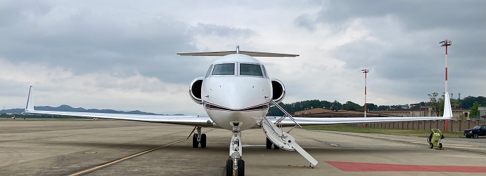 Symmetrical front view of Cessna 172 Skyhawk 2 airplane on an asphalt runway.