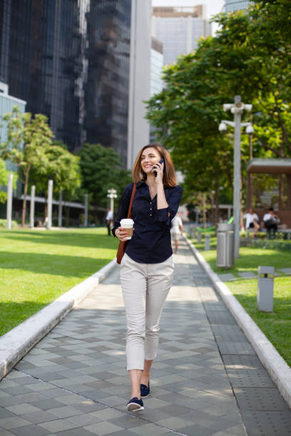 istock Young woman using phone and going up on stairs Hong Kong 1402373553