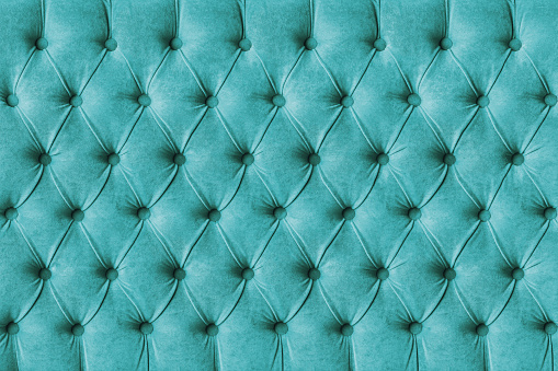 Turquoise capitone checkered soft fabric textile decorative background with buttons. Classic retro Chesterfield style, luxurious upholstery buttoned texture for furniture, wall, headboard, sofa, couch