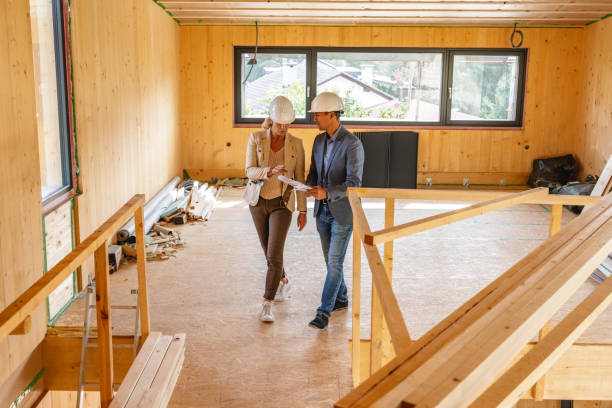 istock Female Architect and Civil Engineer Analyzing Blueprint At Construction Site 1402380851