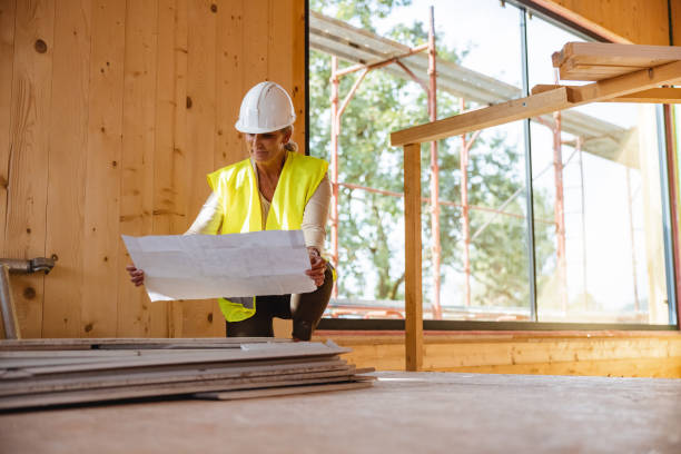 istock Female Civil Engineer Examining Blueprints 1402380854