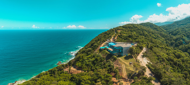 Aerial view the luxurious villa with pool on the edge of the mountain on the ocean coast, La Guaira, Venezuela.