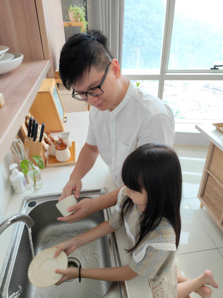 istock Father and daughter washing frets 1402393401