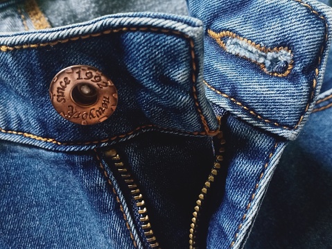 Zipper on blue jeans, closeup 