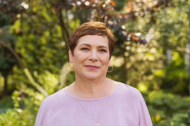 Photo of Portrait of an adult woman on summer blurred background. Age