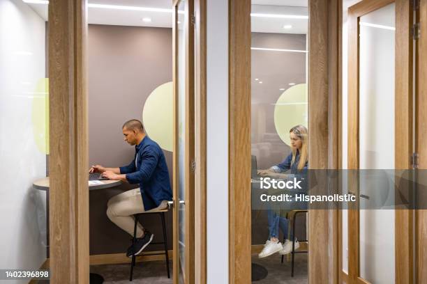 Business People Working In Private Cubicles At A Coworking Office Stock Photo - Download Image Now