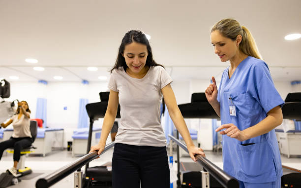 Patient in physical therapy walking on the parallel bars