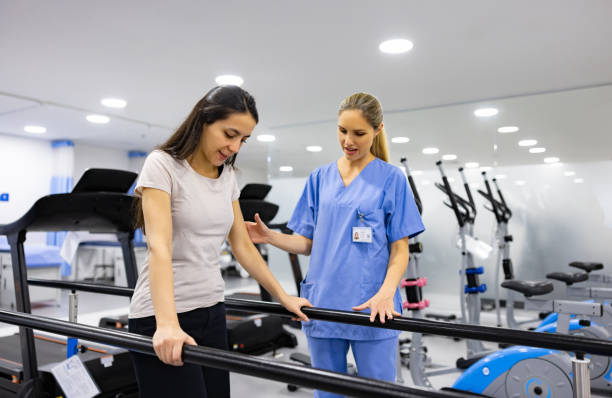 istock Woman in physiotherapy walking on the parallel bars 1402396962