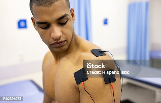 istock Man in physiotherapy getting electrical stimulation therapy on his shoulder 1402396975