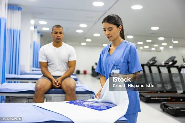 Physiotherapist Preparing An Ice Pack To Put On A Patient Stock Photo - Download Image Now