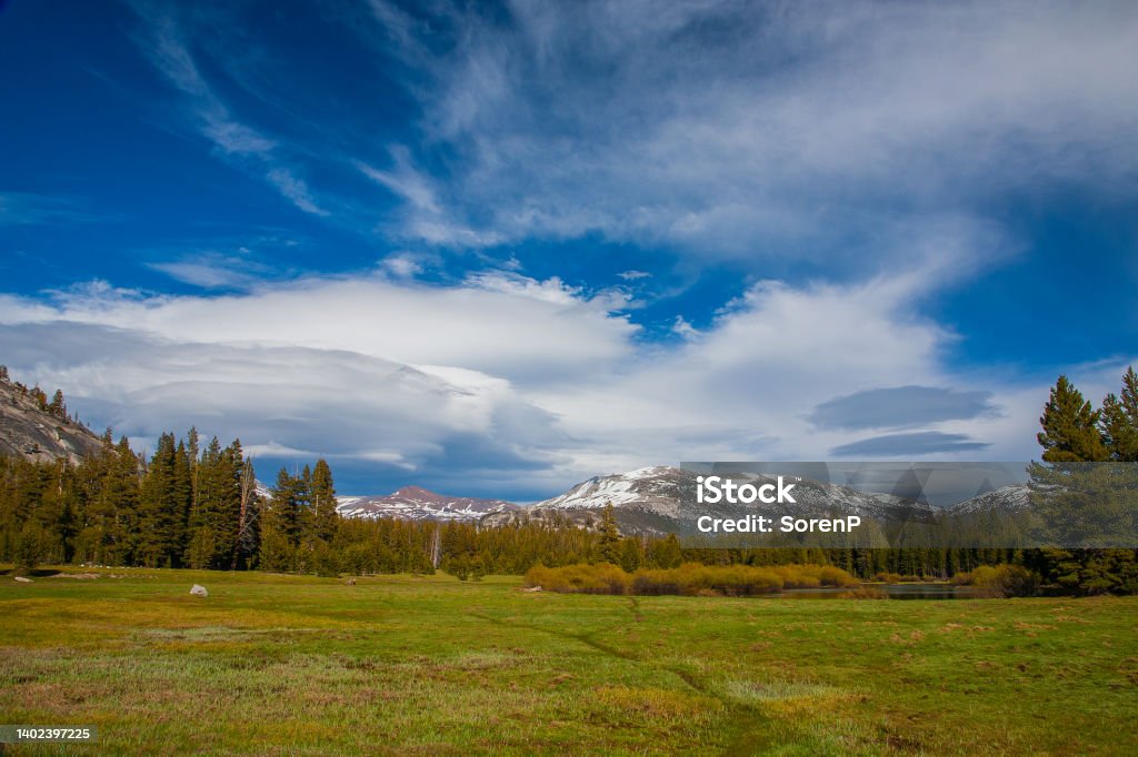 Ble sky Blue sky and stormy clouds approaching over the snow capped mountains in Yosemite National Park. California Stock Photo