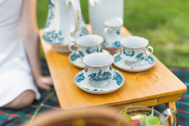istock Old painted tea set. Cups for tea and coffee on picnic table 1402397999