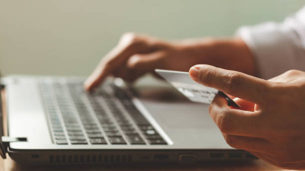 istock Businessman using laptop computer with a credit card making an online order. Business, online shopping, e-commerce, internet banking, spending money, online payment, working from home concept. 1402405555