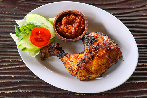 aesthetic honey roasted chicken with vegetables, Asian cuisine menu Balinese and Indonesian food on wooden background