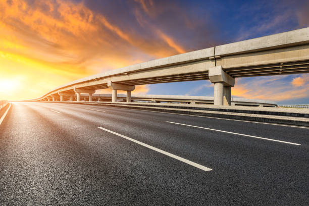 istock Asphalt road and sky clouds at sunrise 1402407863