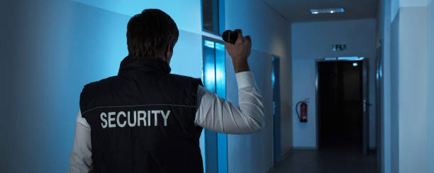 istock Security Guard Standing In Corridor Of The Building 1402409097
