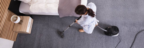 istock Housekeeper Cleaning Carpet With Vacuum Cleaner 1402409663