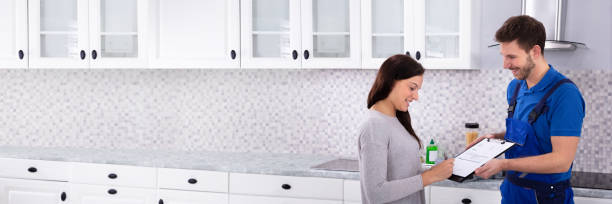 istock Woman Signing Invoice In Kitchen 1402409800