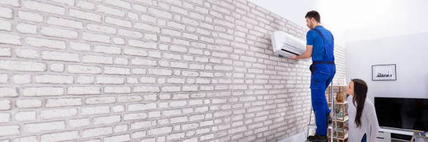 istock Male Technician Fixing Air Conditioner On Wall 1402409811