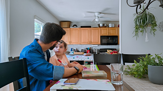 Father helping his daughter with the home work