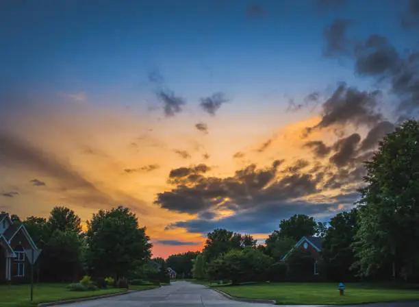 Photo of Beautiful dramatic sky over suburban Midwestern neighborhood at sunset in summer