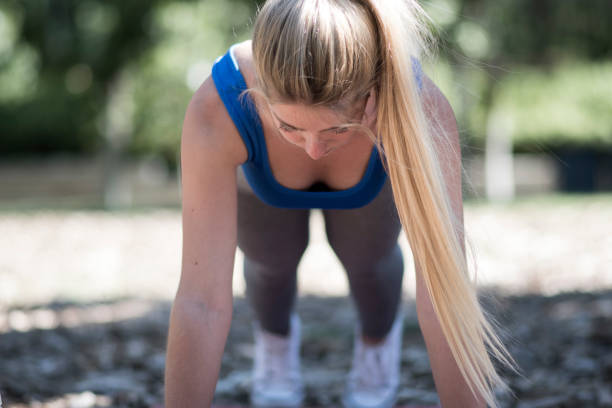 istock blonde girl doing push-ups 1402411223