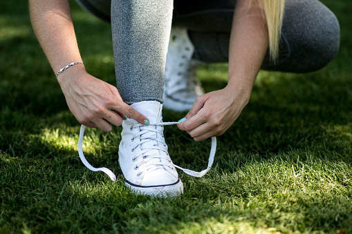 girl tying her sports or casual shoes